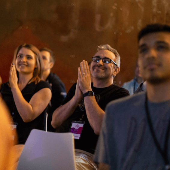 Audience members applauding at FusionConf