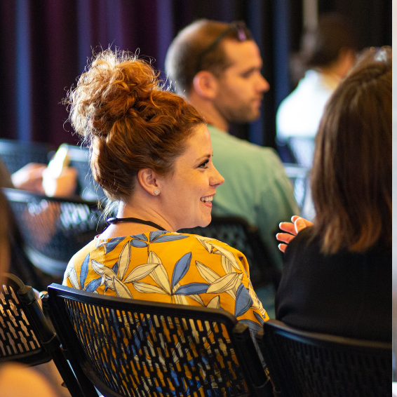 Attendee smiling in audience