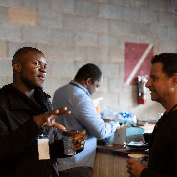 Attendees having conversation over coffee
