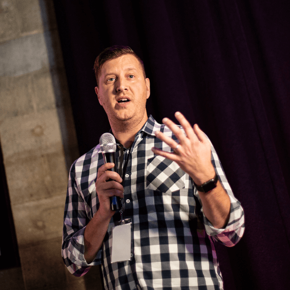 Man speaking with microphone at FusionConf